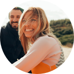 Couple on beach looking happy