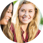 Blonde haired women smiling at friend