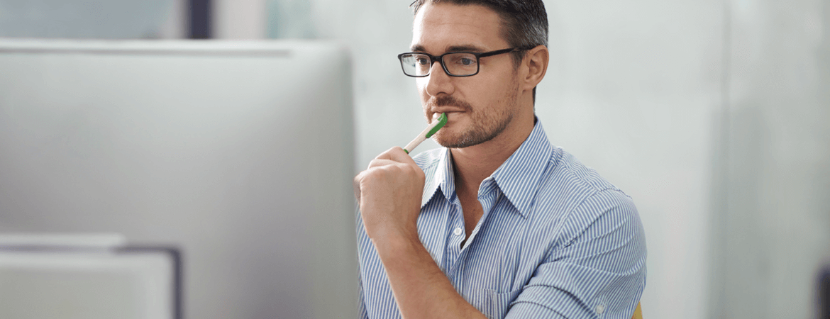 man with glasses on a desktop computer choosing a super fund