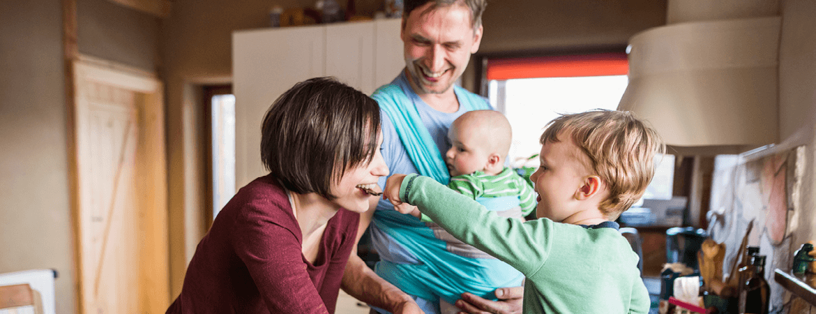 happy young family together in the kitchen of their home