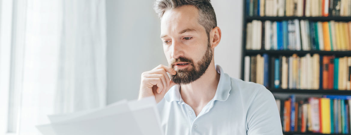 concerned male reading paper work