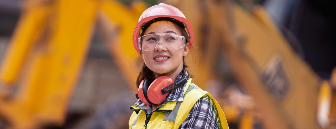 Woman at construction site with high vis gear