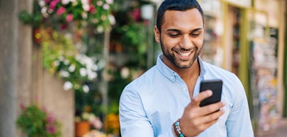 Man smiling at mobile phone