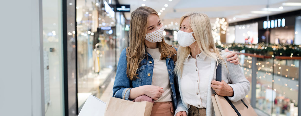 Mother and daughter christmas shopping with masks on