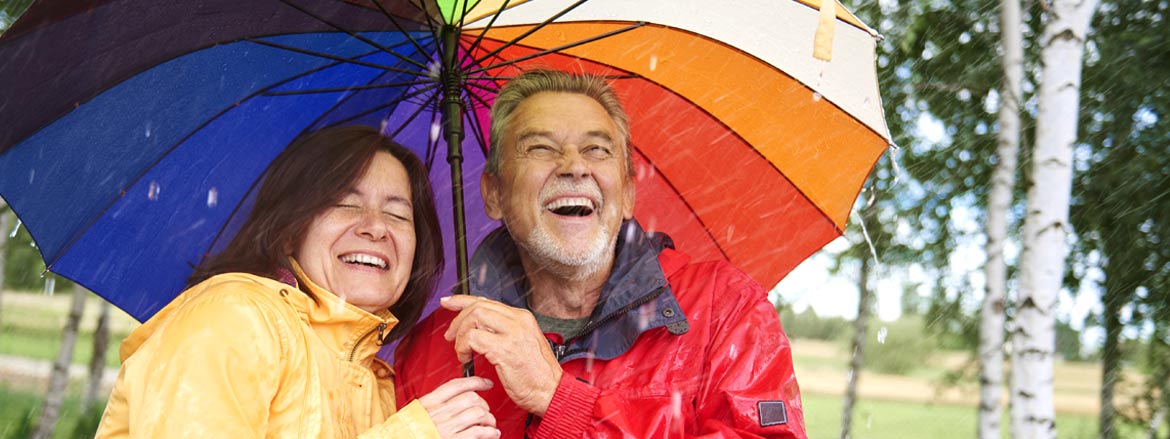 Retired couple under an umbrella