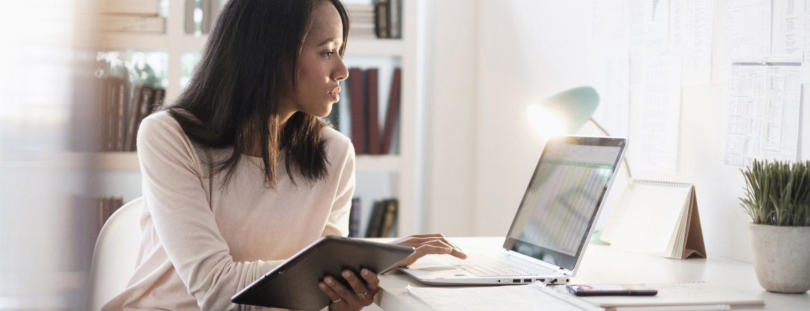 Mixed-race business woman using laptop
